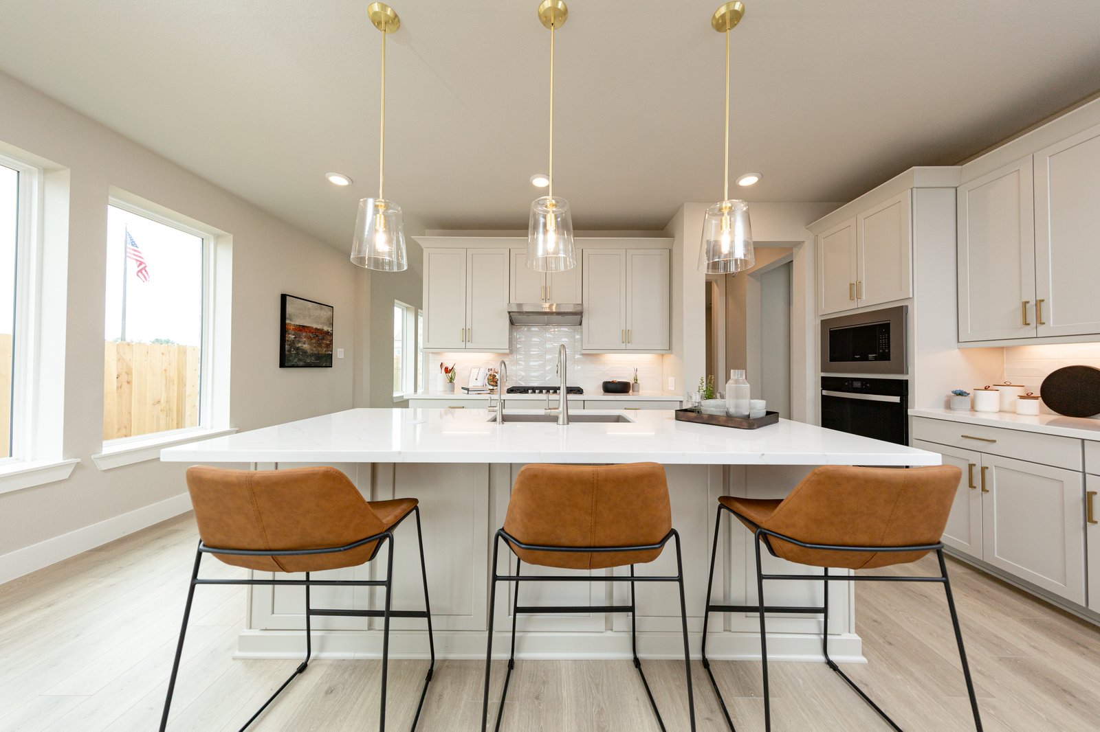 open kitchen with hardwood flooring and beige cabinets