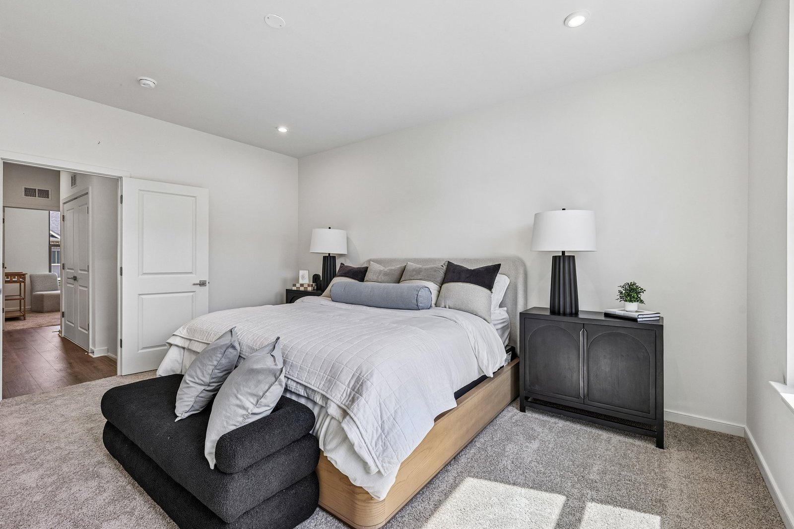 primary bedroom with a bench at the foot of the bed