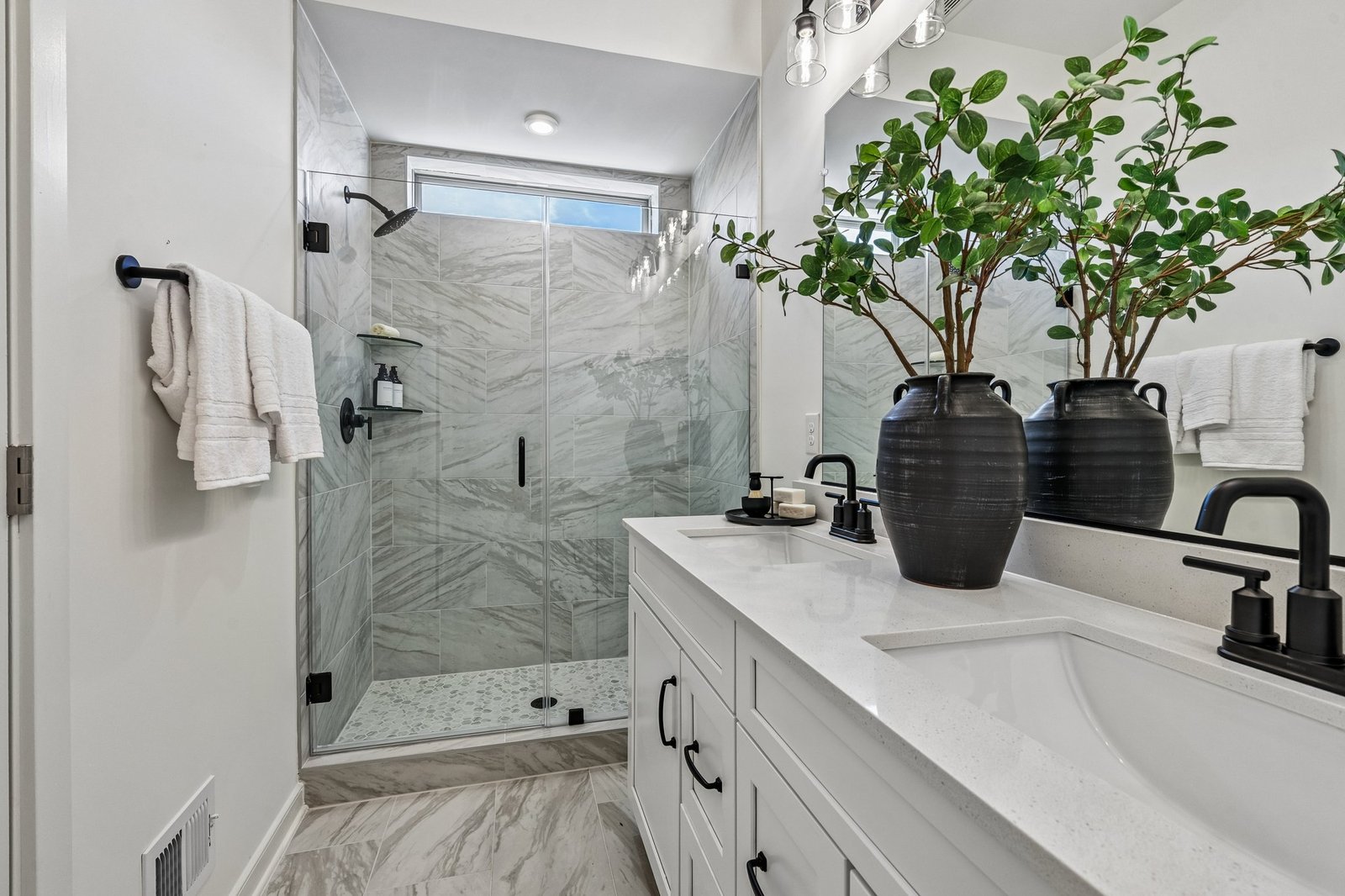 primary bathroom with a shower with a window