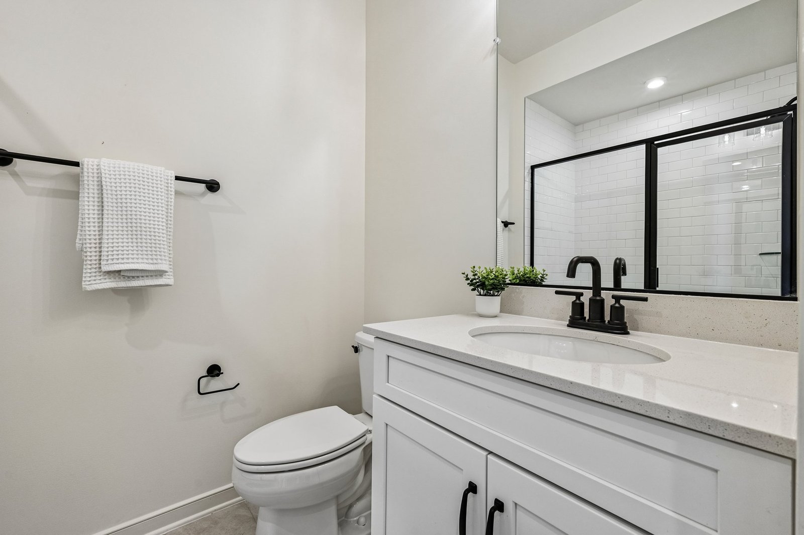 secondary bathroom with a walk-in shower