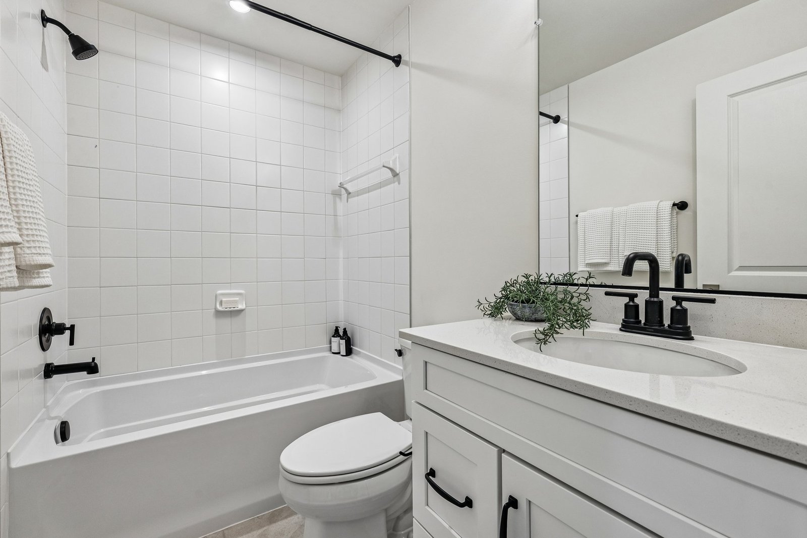 secondary bathroom with a shower and tub combo