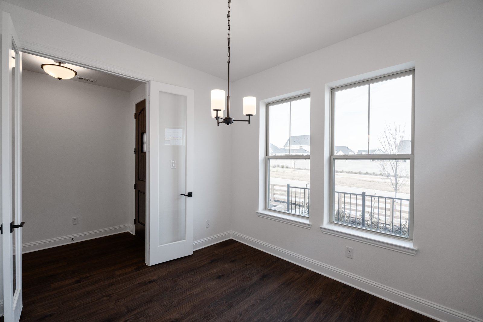 private study with wood floors and french doors