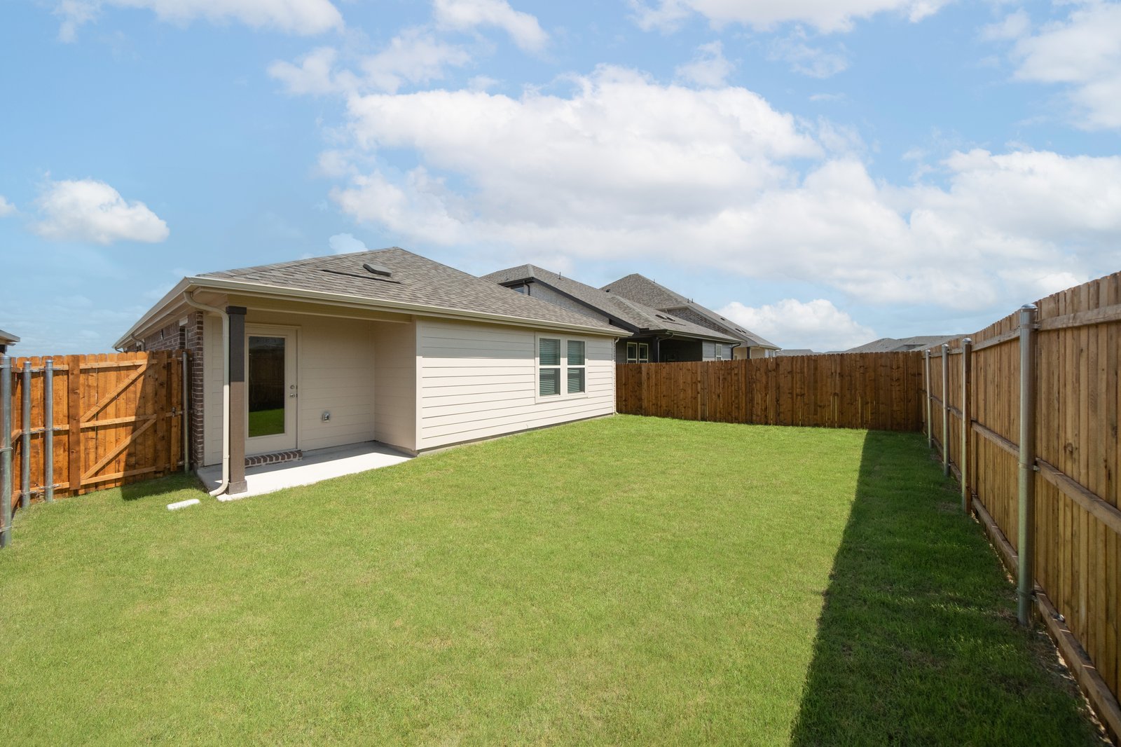 backyard with grass and covered patio