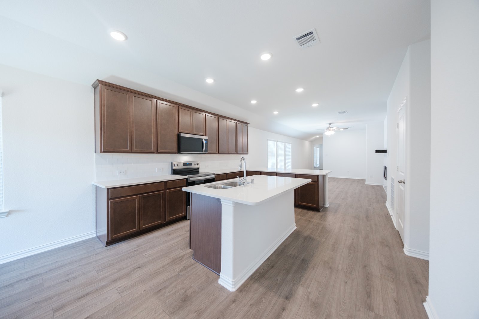 open kitchen with wood floors and island