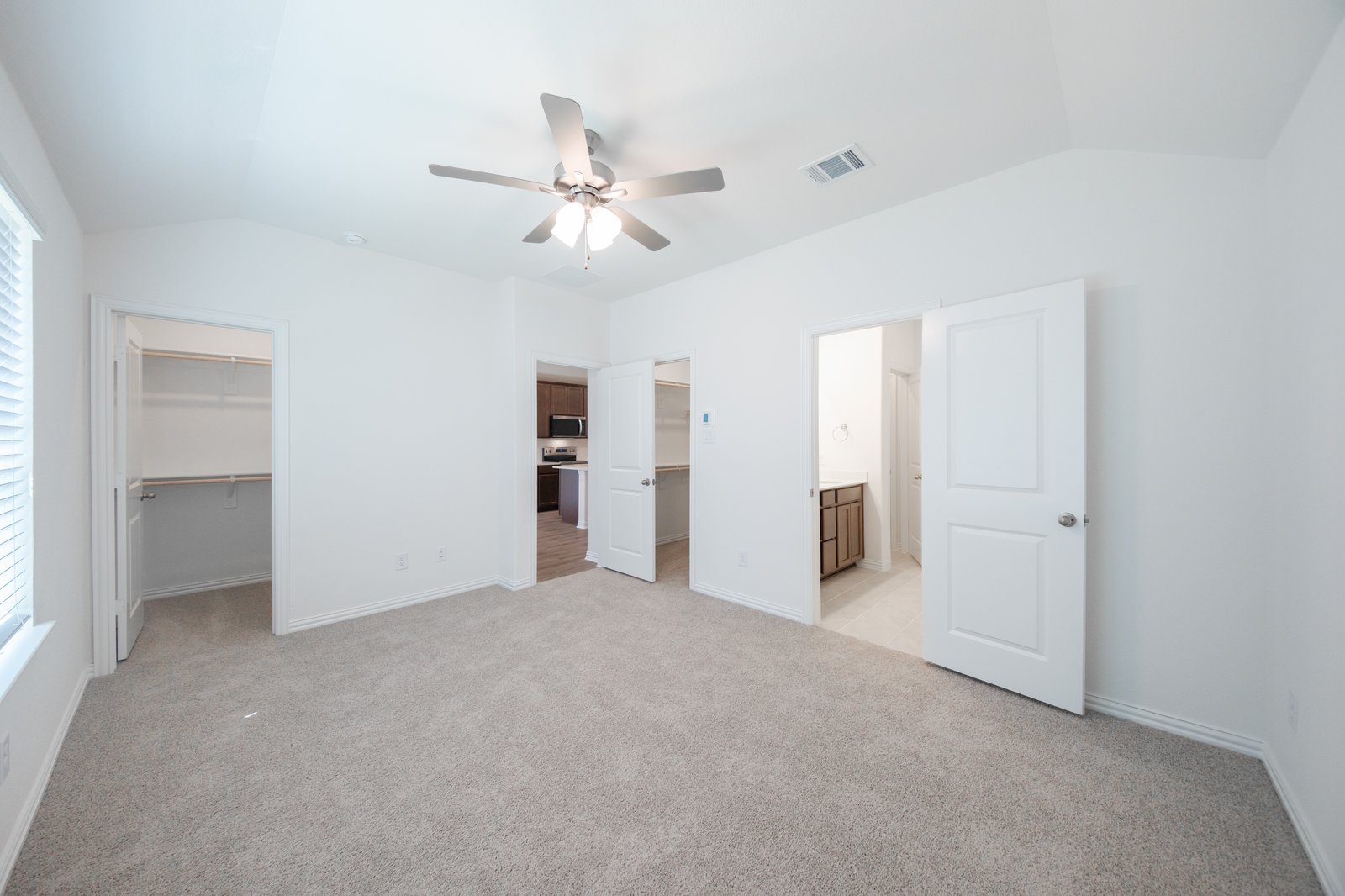 primary bedroom with carpet and ceiling fan
