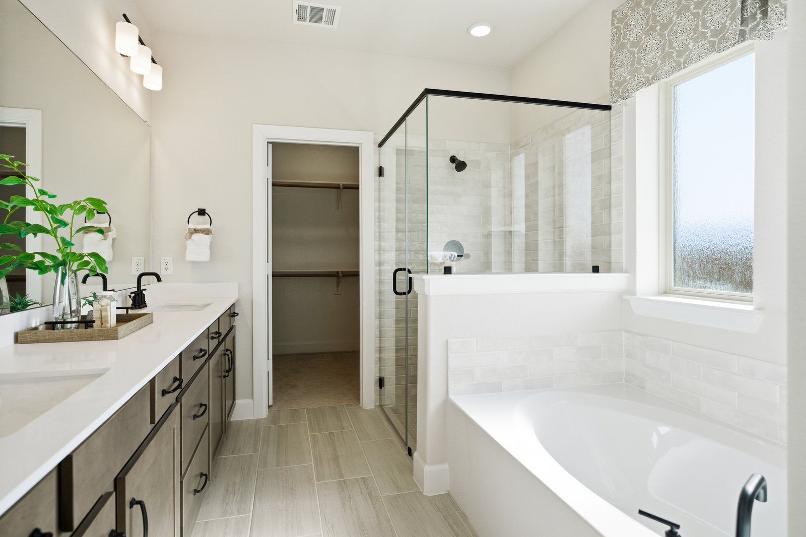 primary bathroom with separate soaking tub and shower