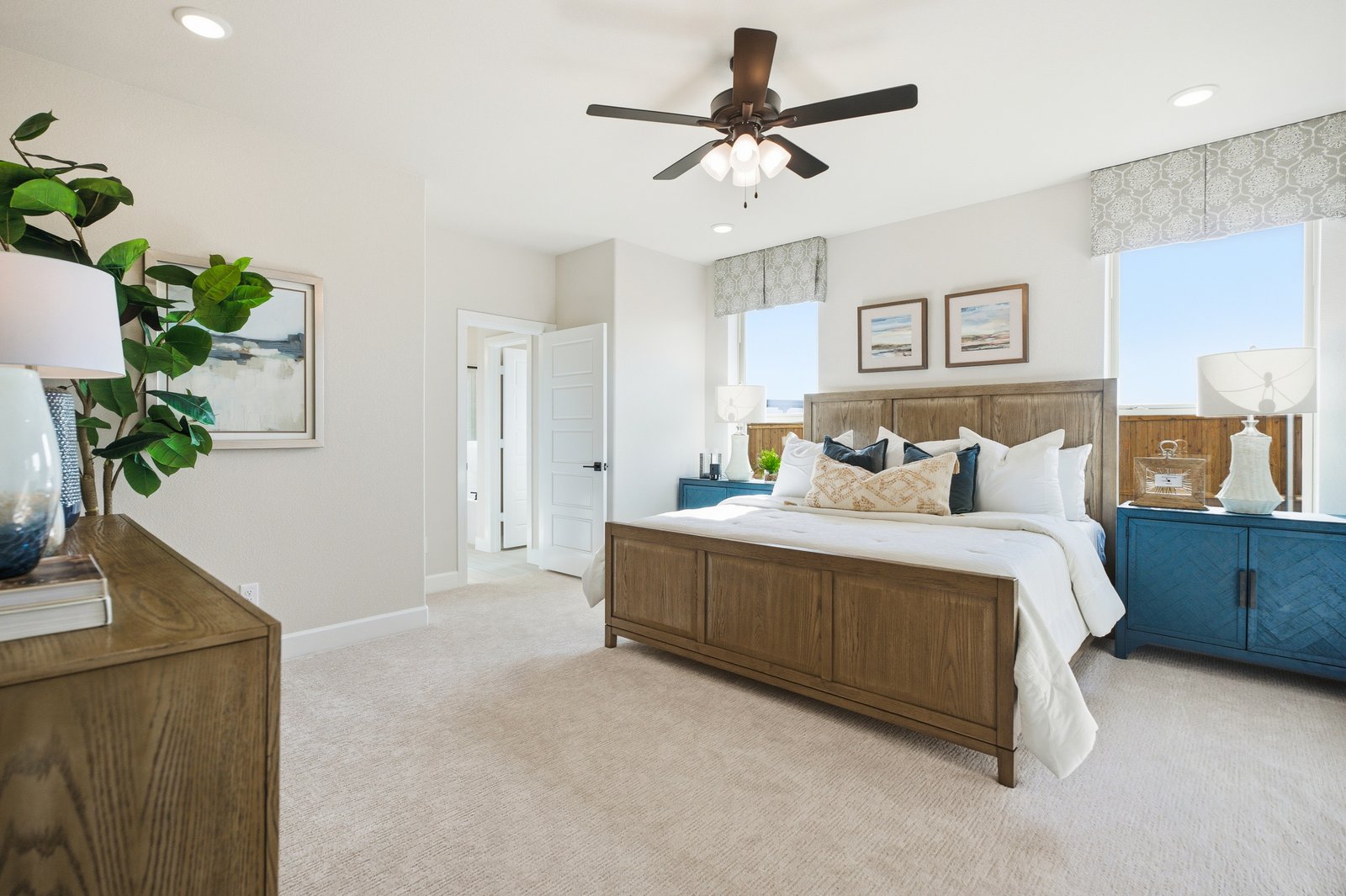 primary bedroom with carpet and windows