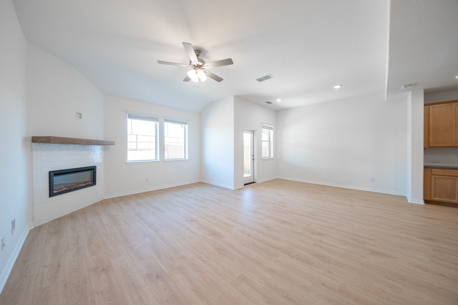 open great room with wood floors and fireplace