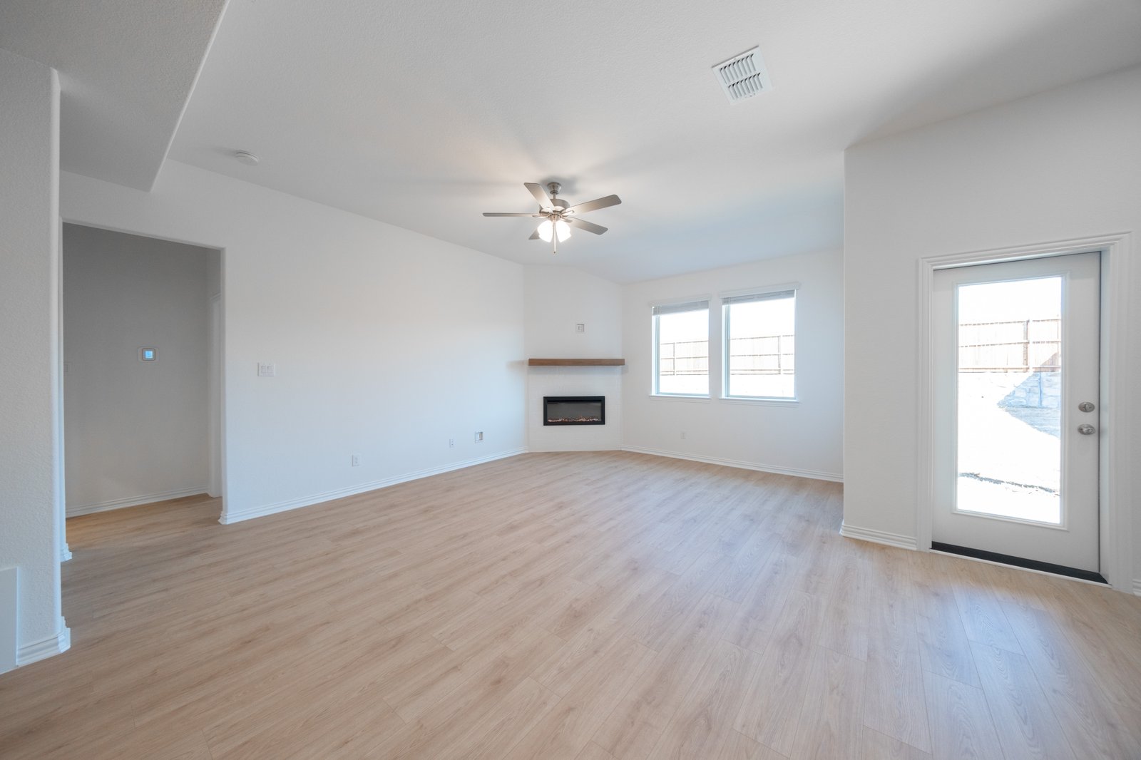 open great room with wood floors and fireplace