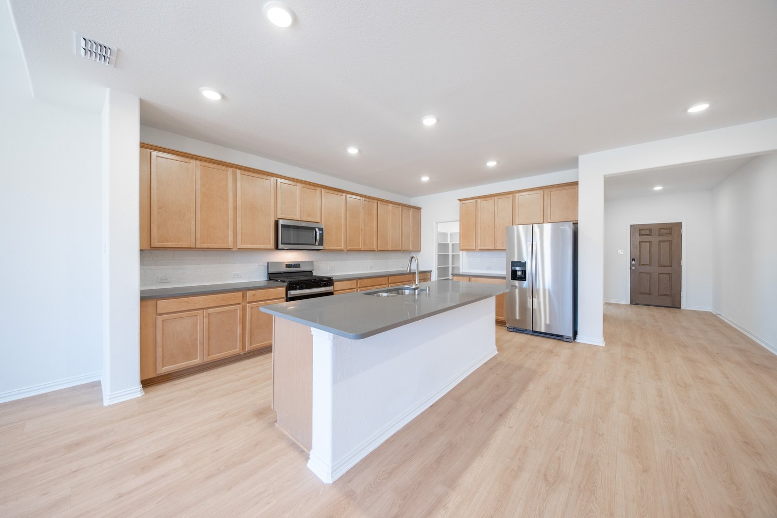 open kitchen with wood floors and island