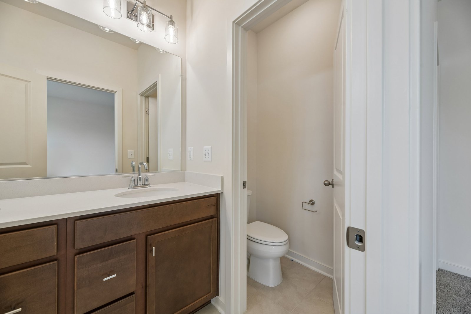 primary bathroom with a toilet room
