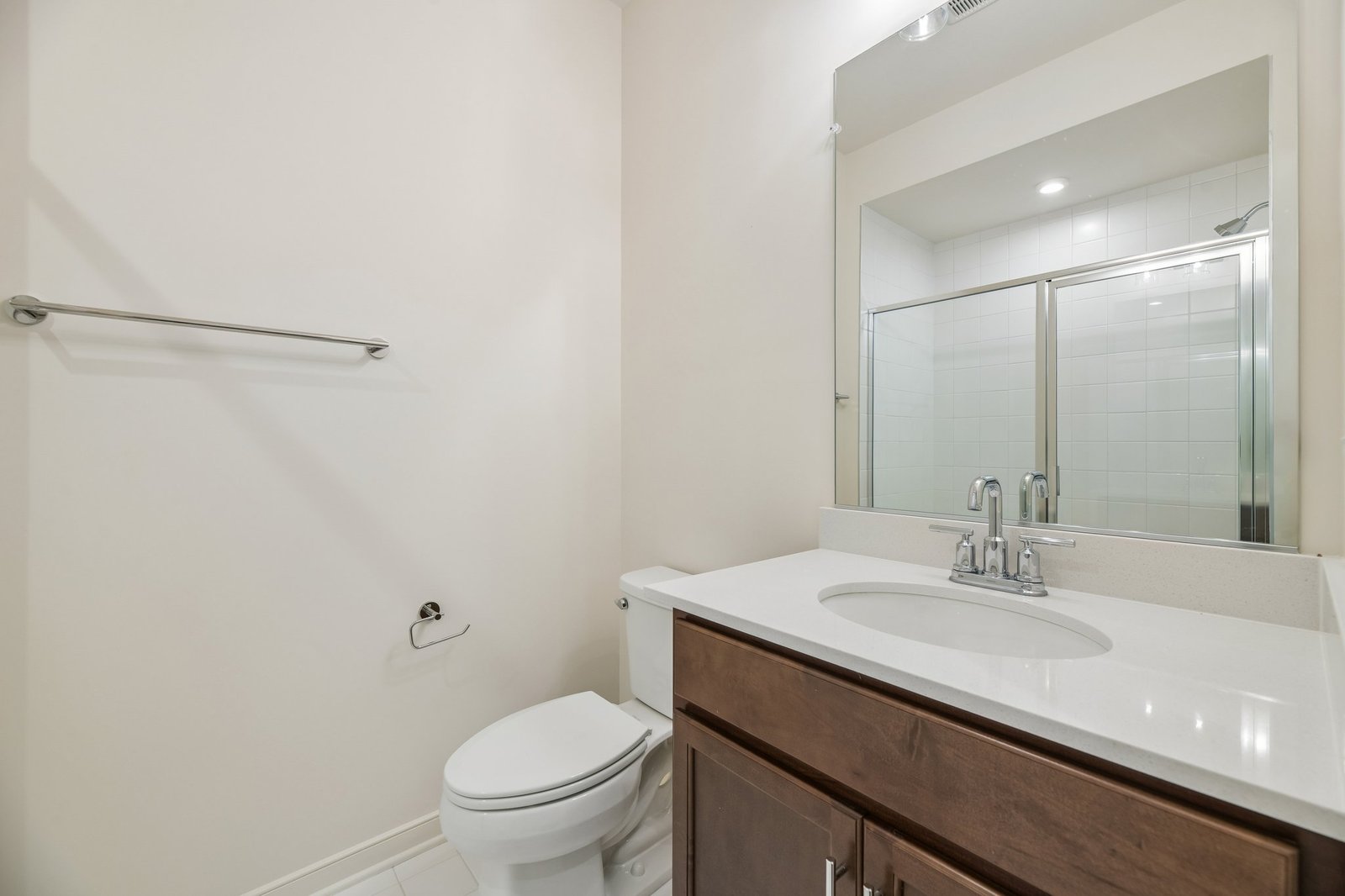 secondary bathroom with a walk-in shower