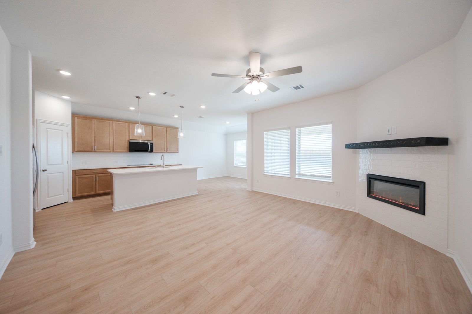 great room with wood flooring and fireplace