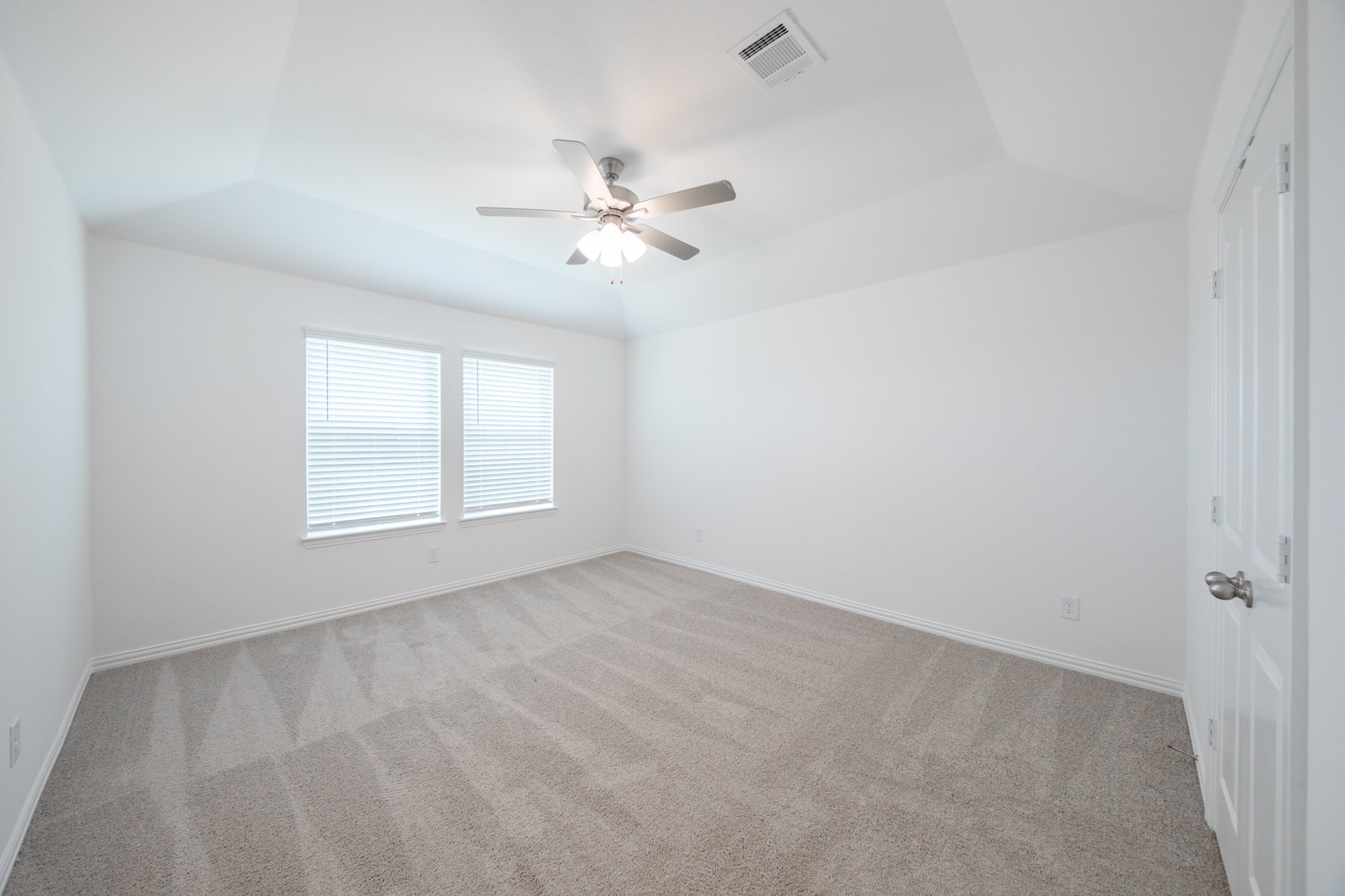 bedroom with windows with blinds