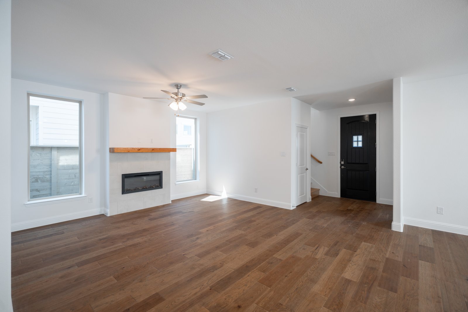 open great room with wood floors and fireplace