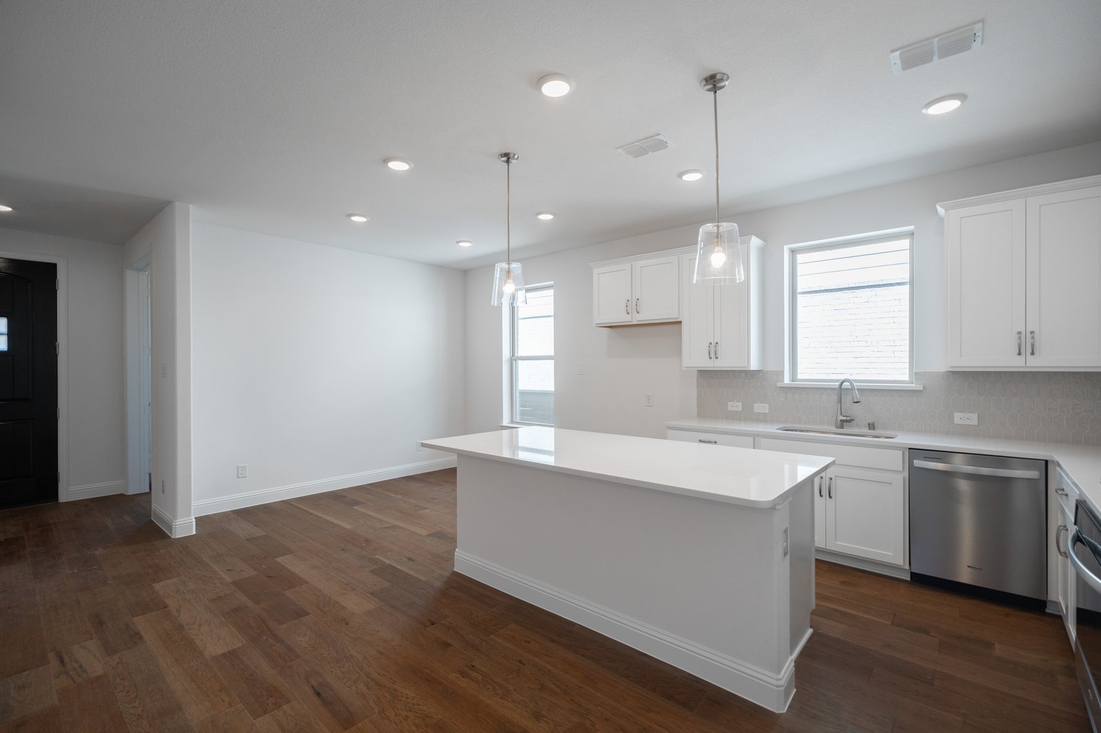 open kitchen with wood floors and island
