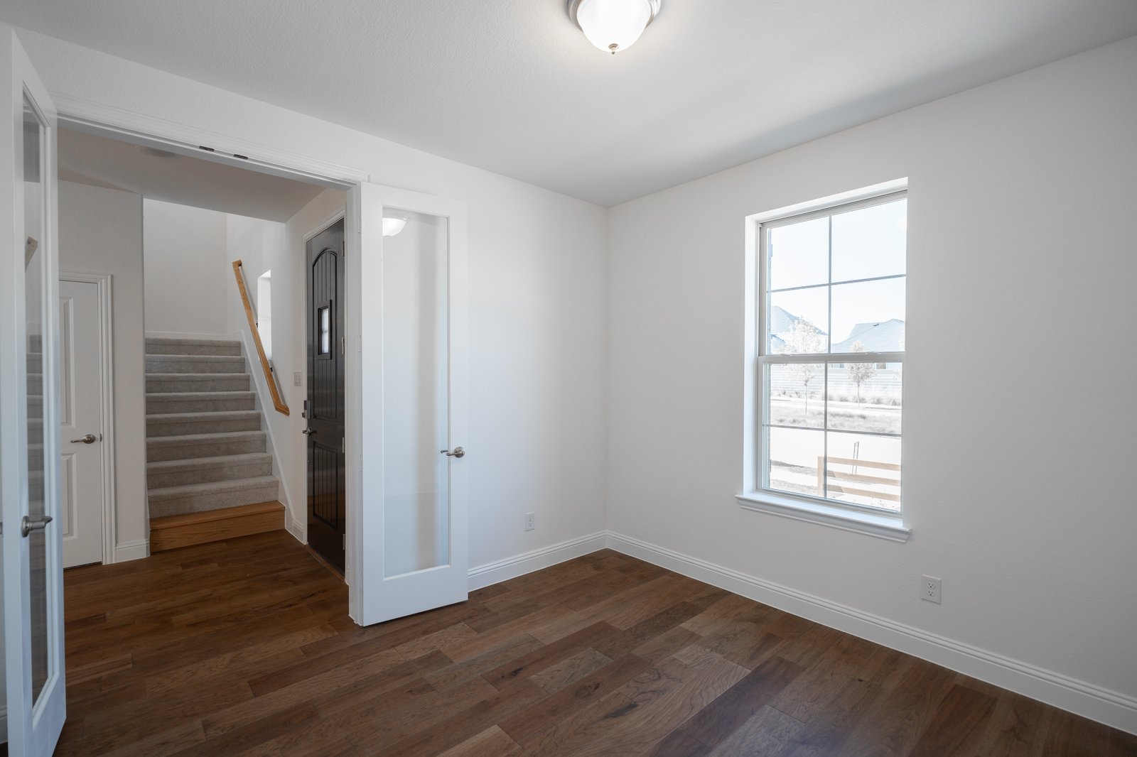 private study with wood floors and french doors