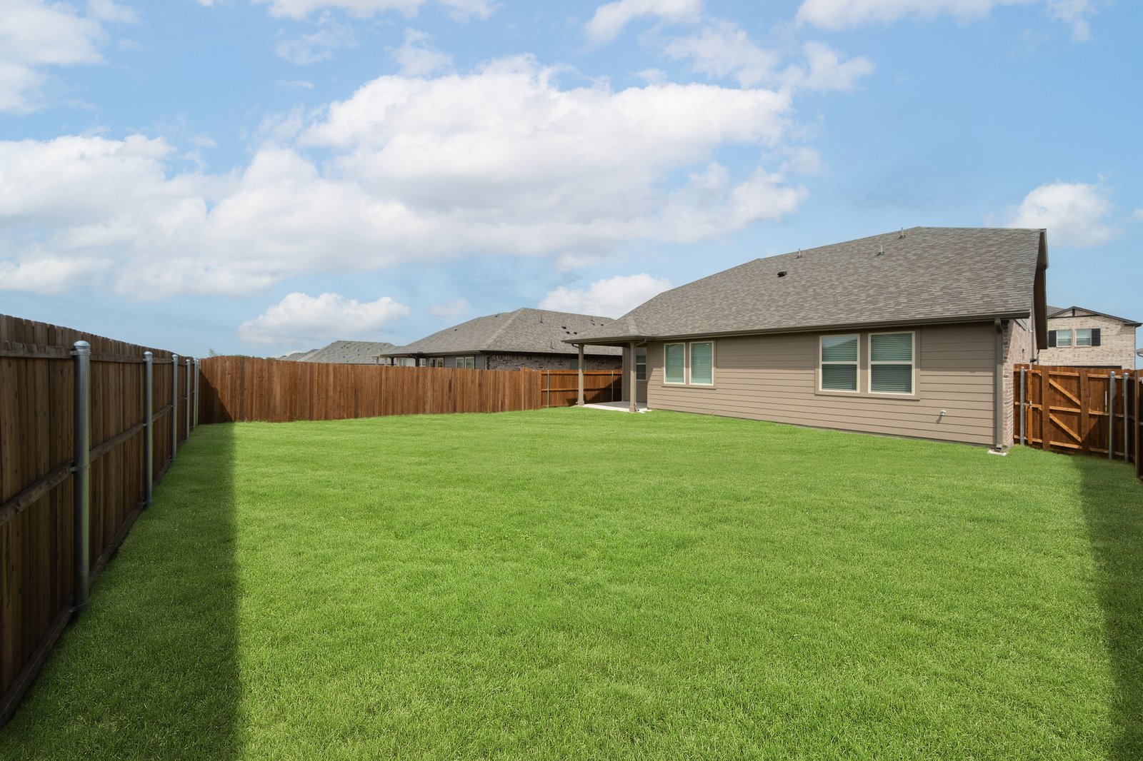 backyard with grass and covered patio