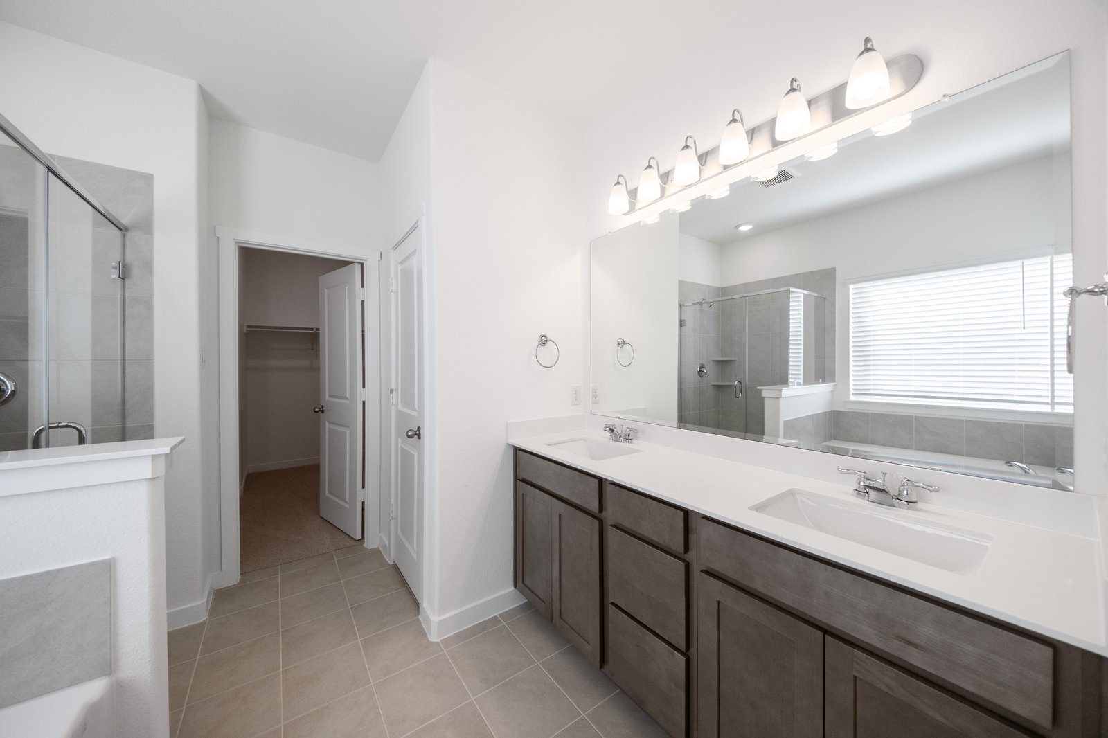 bathroom with white countertops and dark cabinets