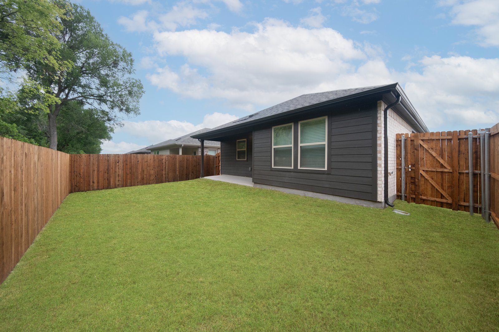 backyard with grass and covered patio
