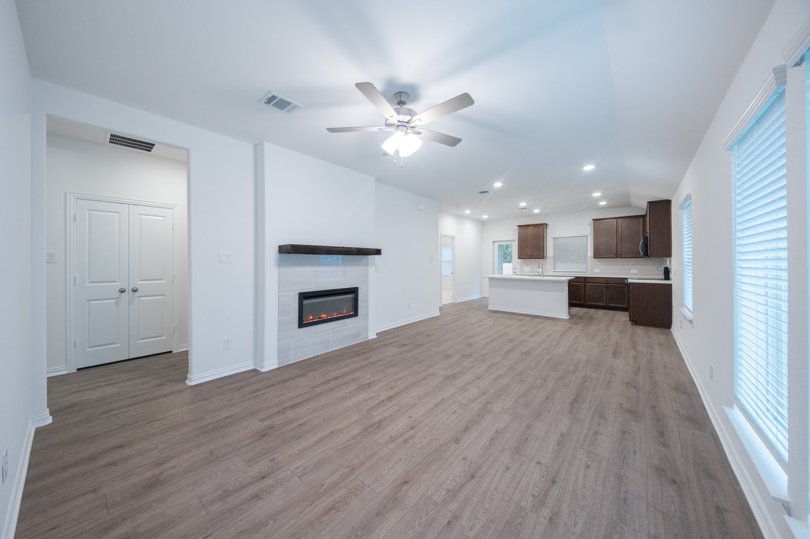 open great room with wood floors and fireplace