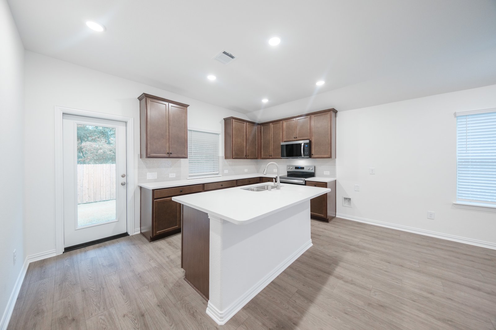 open kitchen with wood floors and island