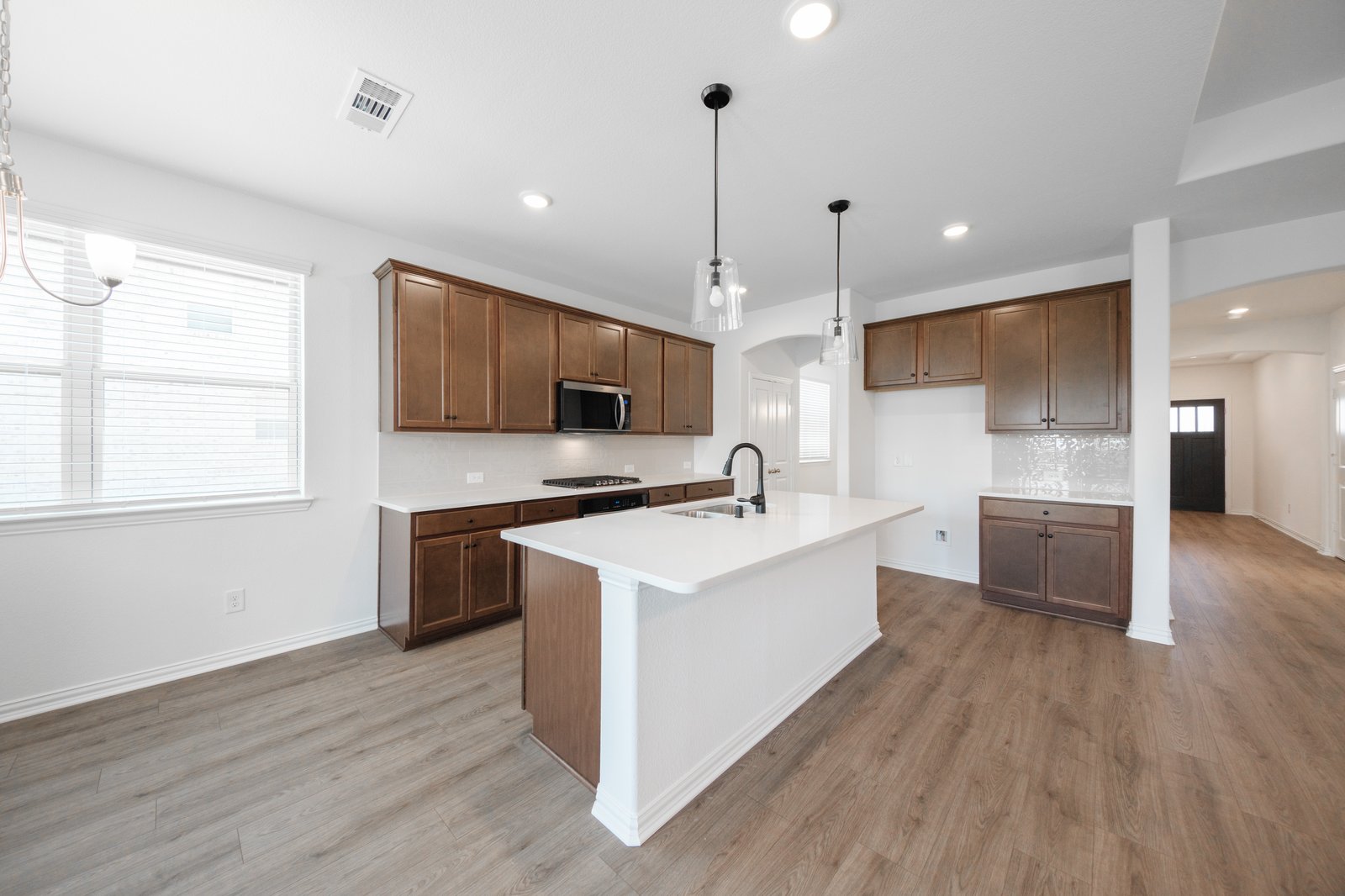 open kitchen with wood floors and island