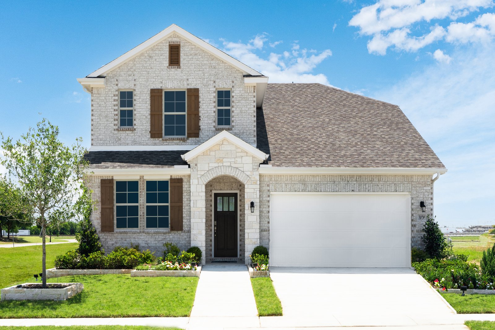 two-story home with a brick and stone exterior