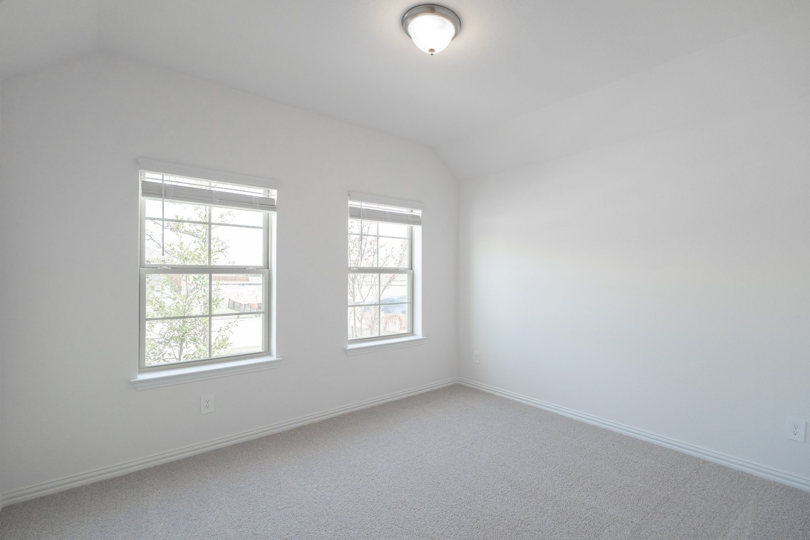bedroom with two windows with window blinds