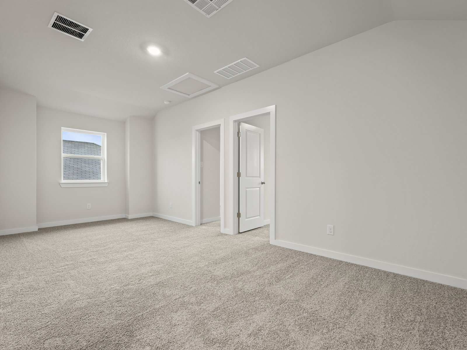 loft with carpet, window and entrance to bedrooms