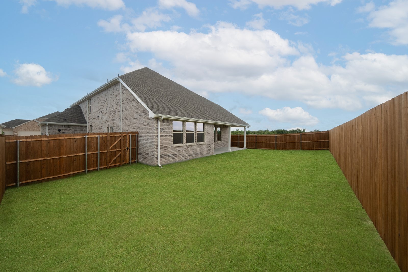  backyard with grass and covered patio