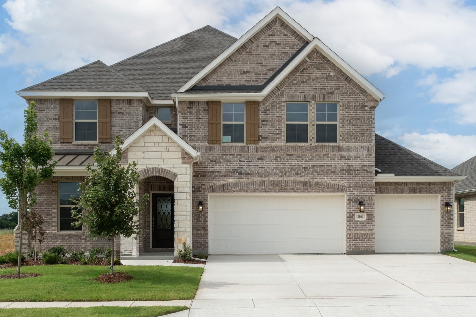 two-story home with brick and stone exterior