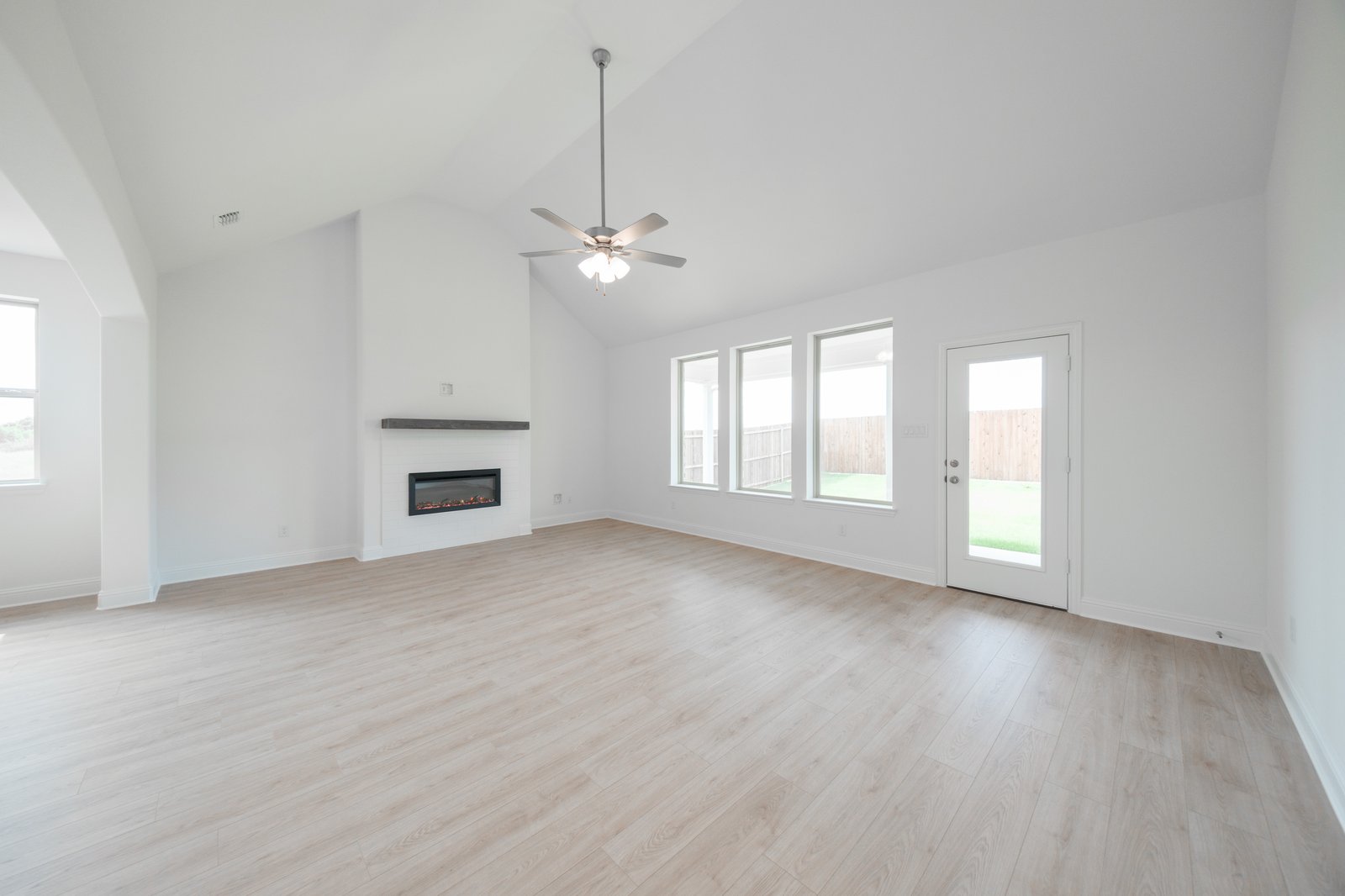 open great room with wood floors and fireplace