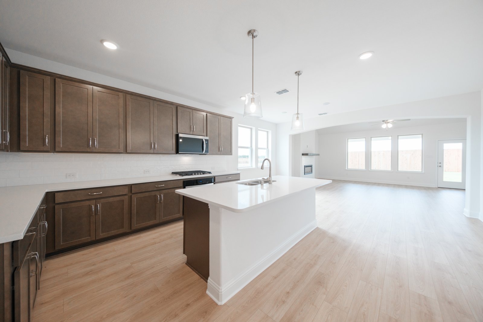open kitchen with wood floors and island