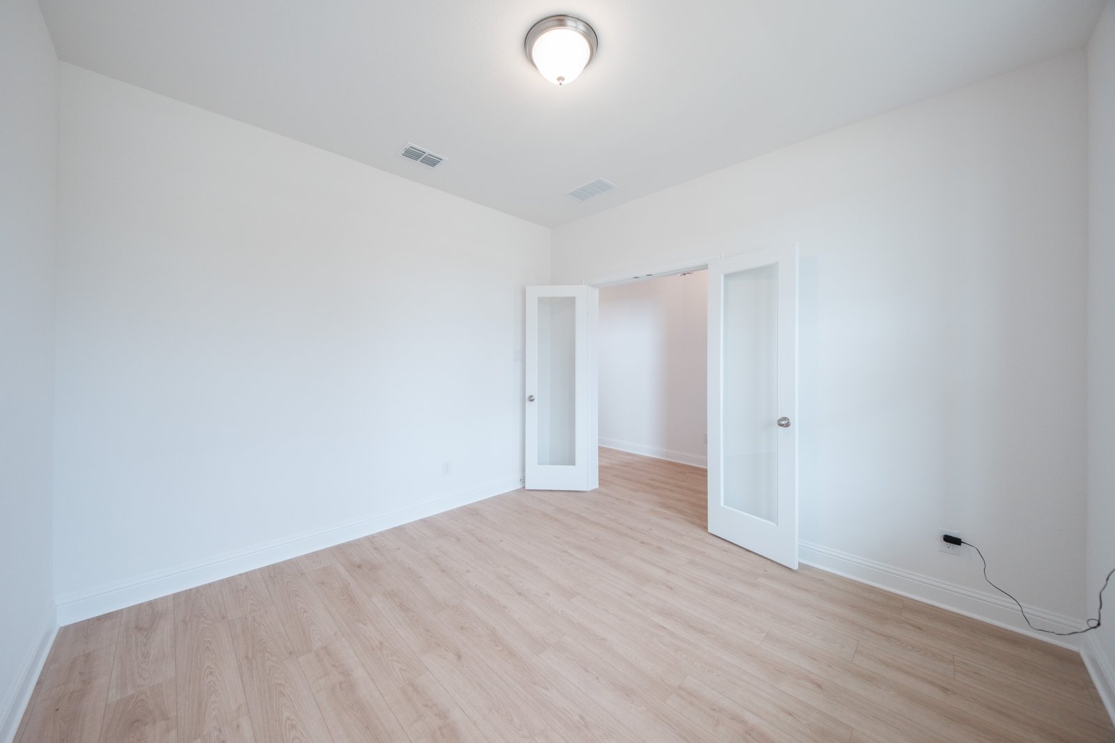 private study with wood floors and windows