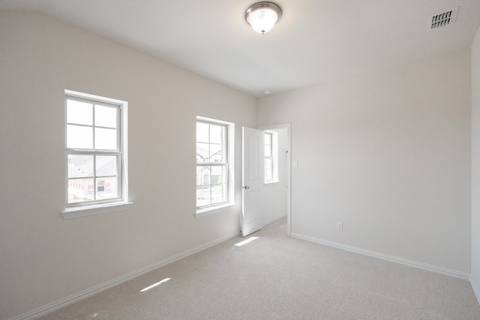bedroom with carpet and windows 
