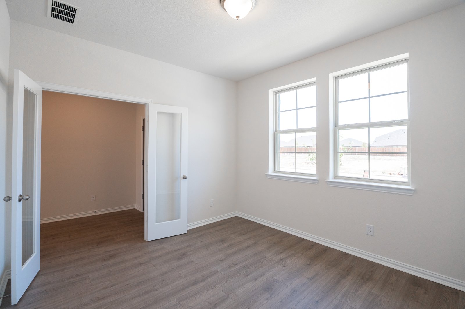 study with wood flooring and french doors 