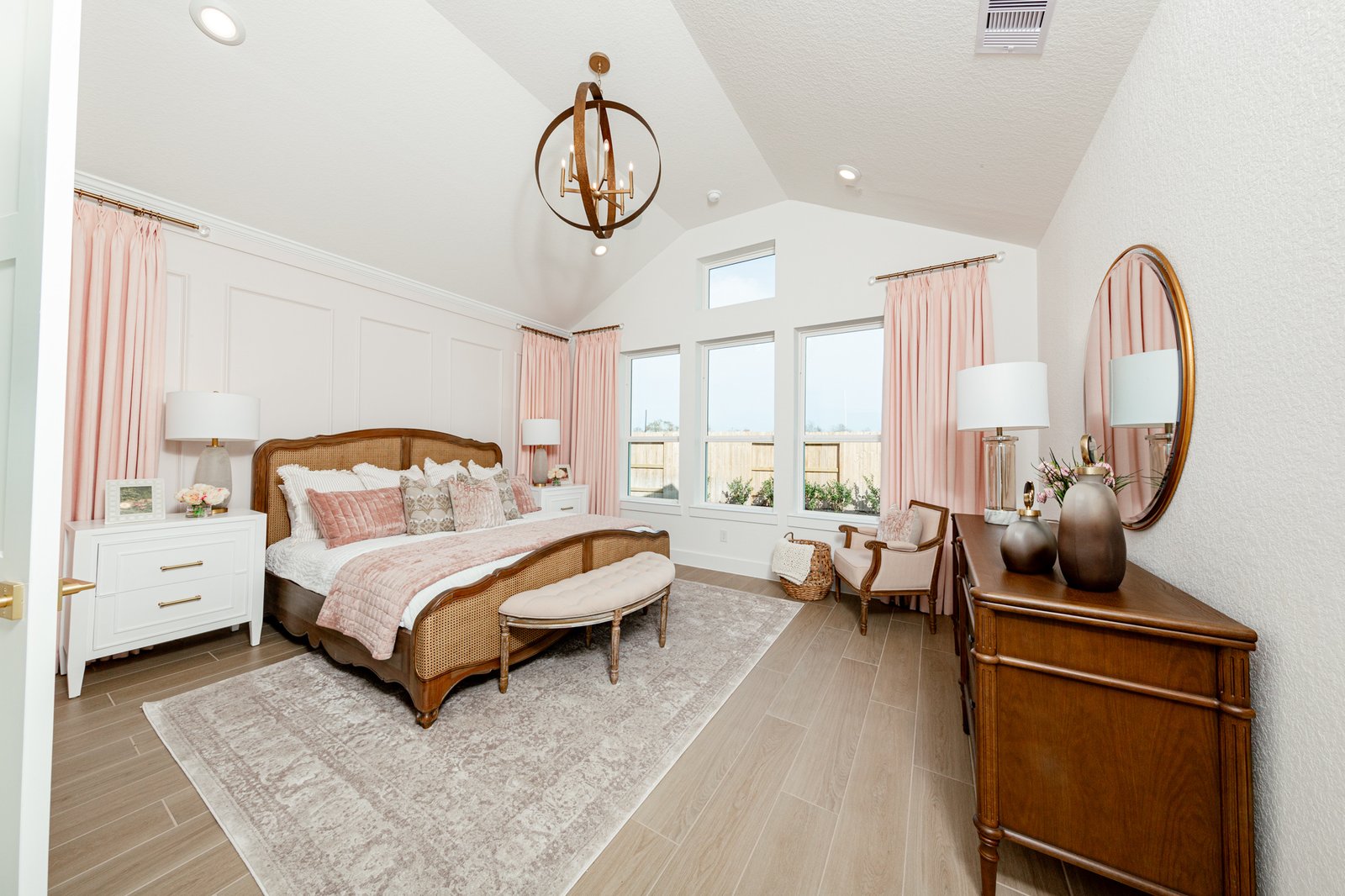 spacious primary bedroom with carpet and windows