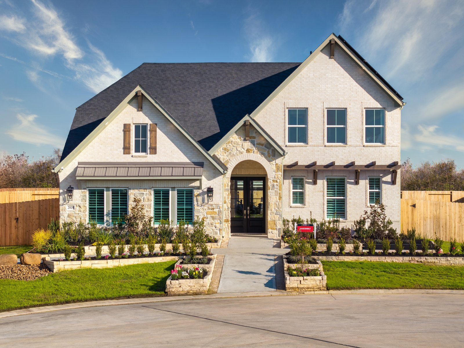 exterior of home with white brick and brown stone