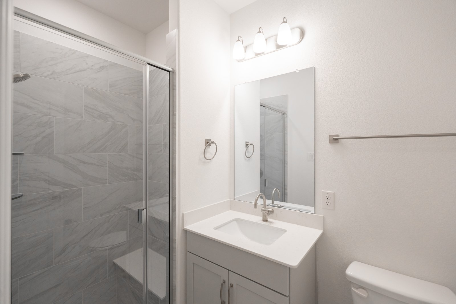 bathroom with walk-in shower and white countertops 