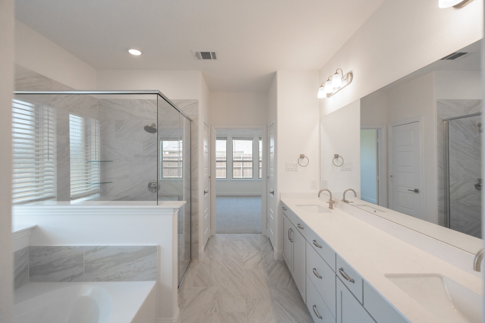 bathroom with white countertops, walk-in shower, and tub 