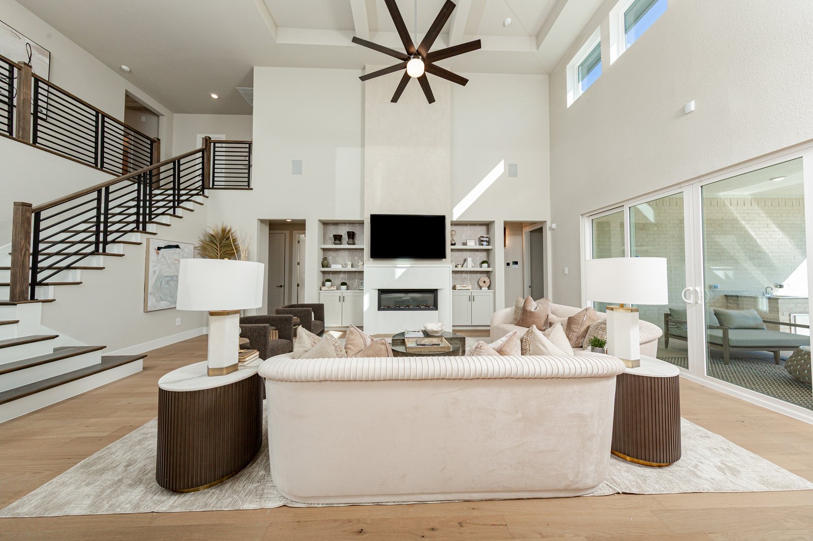 great room with two-story ceilings and hardwood flooring