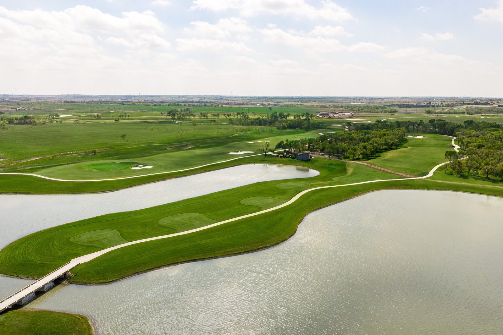 view of golf course course with pond 