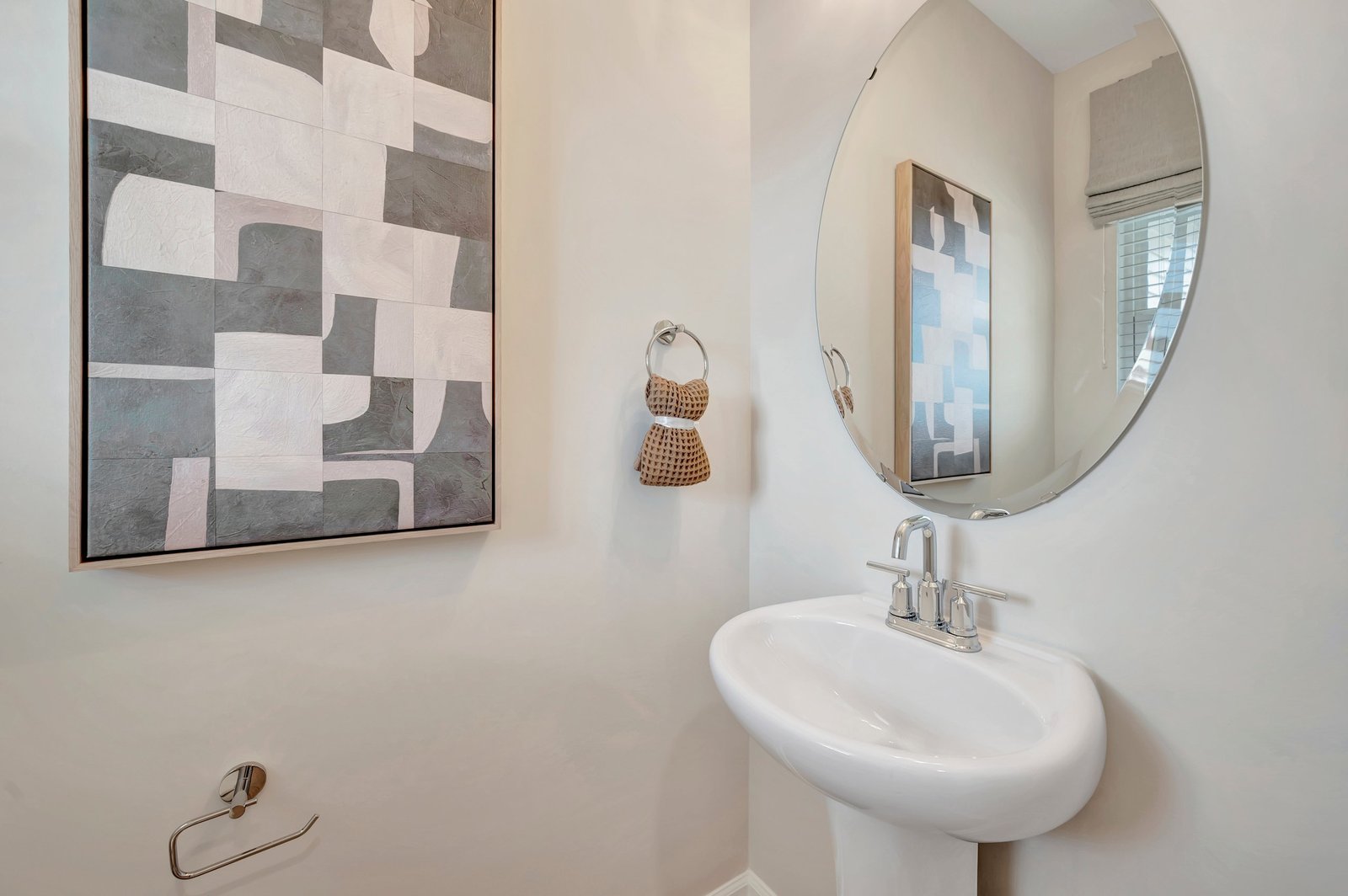 powder room with an oval mirror