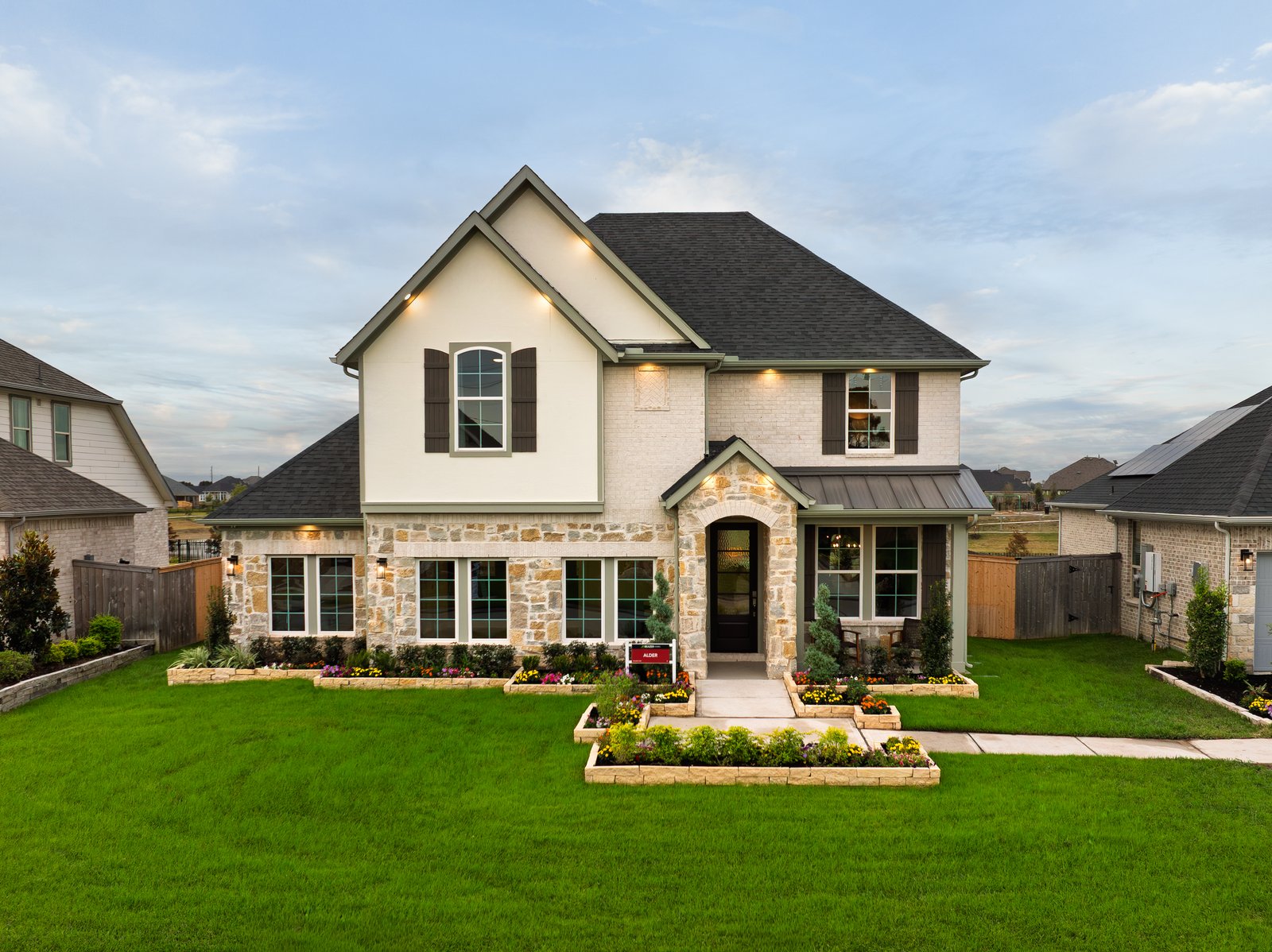 exterior of home with brown brick and white stone