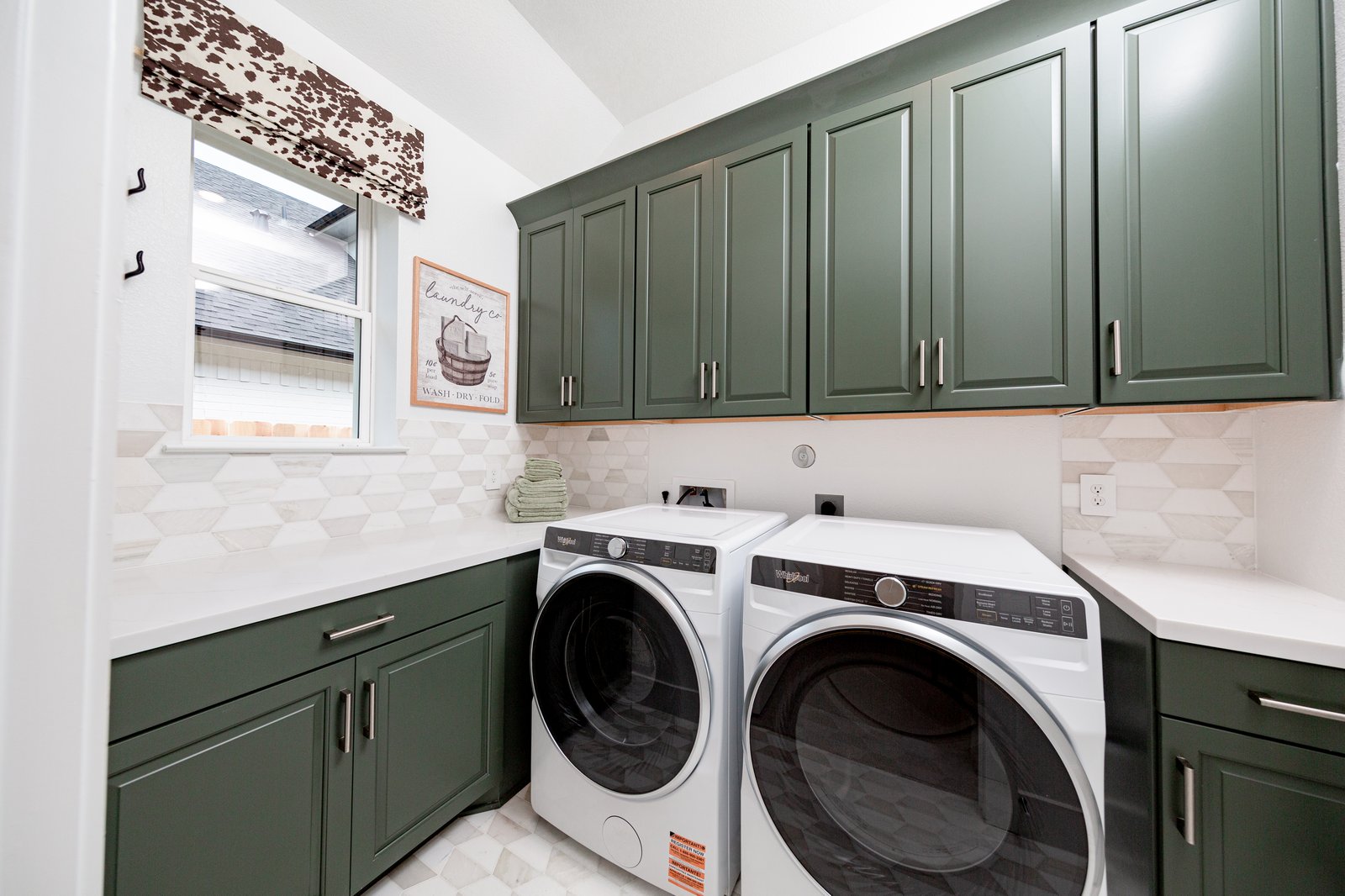 laundry room with storage cabinets