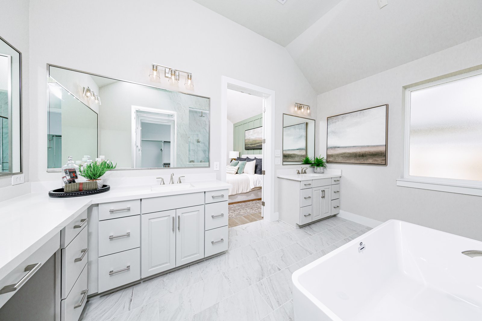primary bathroom with tile flooring and double sinks