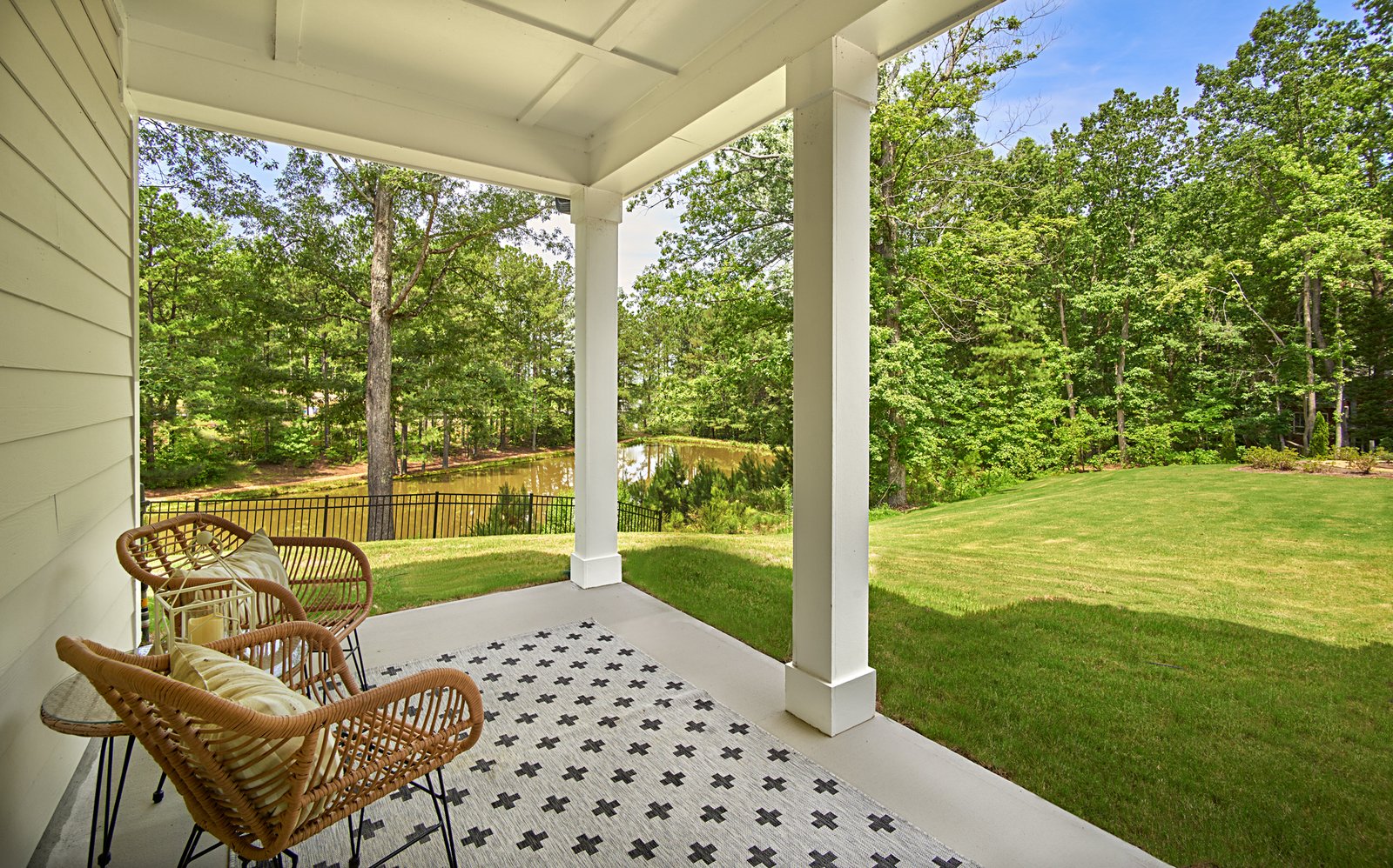 patio with a couple of chairs and a side table