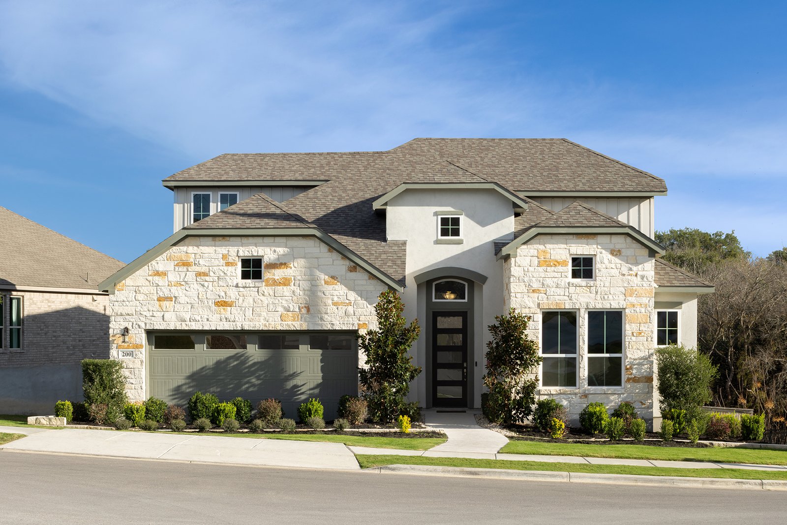 exterior with brick, stone & grass