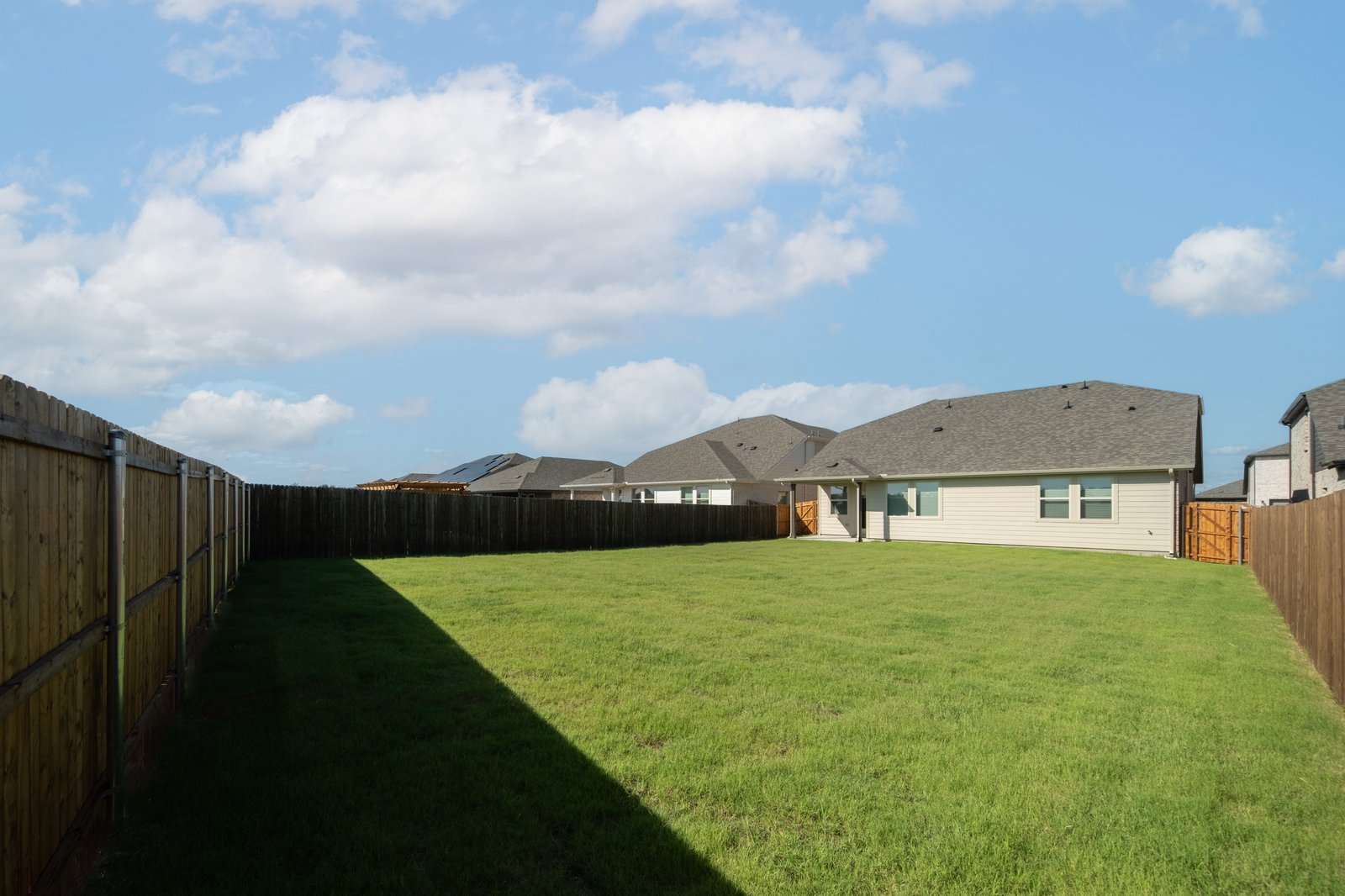 backyard with grass and covered patio